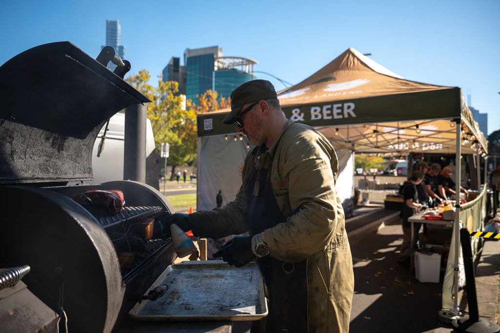 Pitmaster working the smoker, Anzac Day 2026